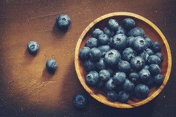 Overhead view of fresh Blueberries on dark wooden background with copy space