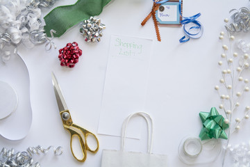 christmas wrapping of gifts with shopping list styled stock view from the top