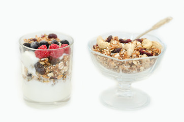Granola with berries and yogurt on a white background. Traditional American Breakfast