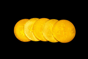 Five Bitcoin coins on a black background. Stack