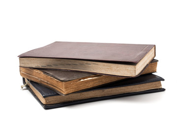 A stack of old books on a white background.
