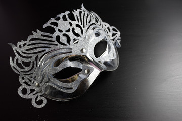 Silver mardi gras mask , Placed on a Black background.