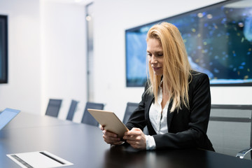 Beautiful businesswoman using digital tablet in office