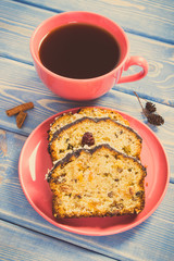 Vintage photo, Cup of coffee and fresh baked fruitcake on boards, delicious dessert