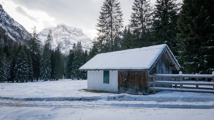 Mountain chalet in snowy alpine valley