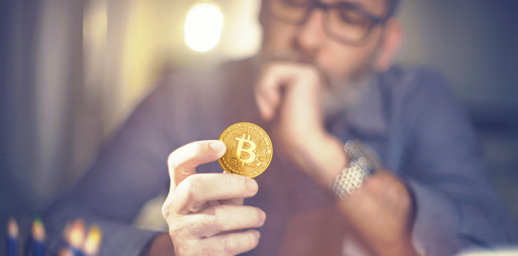 Bitcoin in hand of a businessman thinking about the future
