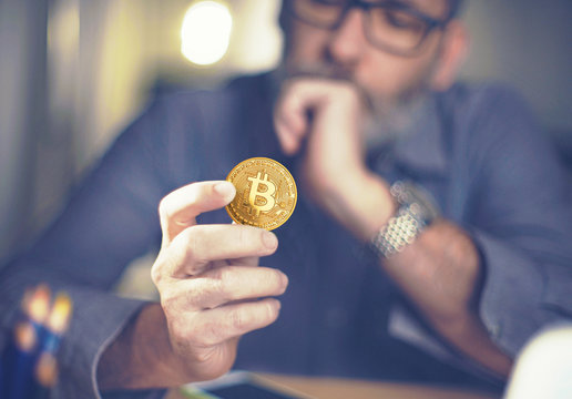 Bitcoin in hand of a businessman thinking about the future