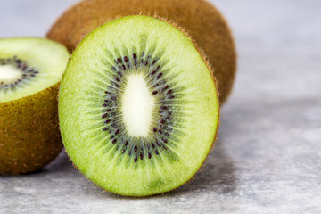 Half of juicy kiwi fruit on background.