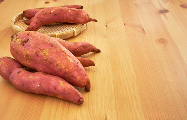 Sweet potatoes on a rustic wooden table
