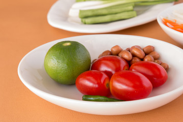 Papaya Salad - Tomatoes, Lemon, Roasted peanuts, Long-beans for Green Papaya Salad with Carrot,  and lettuce. Traditional spicy Thai food. Closeup