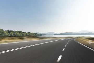 Naklejka premium empty asphalt road with beautiful lake