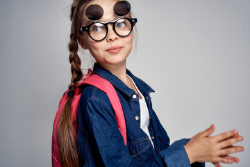 a young girl with glasses is having fun