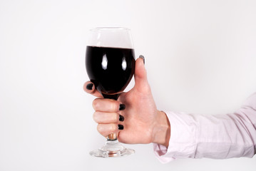 Female hands with red wine glass isolated on white background. Close up
