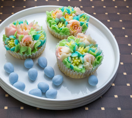 Top view decorated cupcakes with Easter eggs on the table.