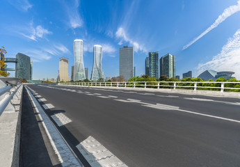 Fototapeta premium empty asphalt road on modern bridge with city skyline background.