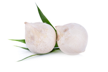 whole young coconut with leaf on white background