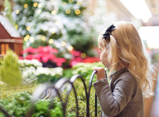 Young girl mesmerized by holiday train exhibit - holiday spirit