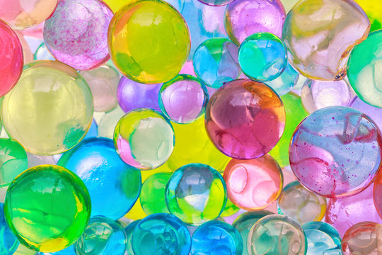 Color balls, colored polymer gel, hydrogel beads background, close up