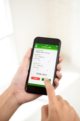 Woman confirming online money payment for car rental booking reservation on smartphone