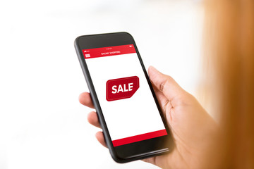 Woman checking cyber sale online shopping discount promotion on smartphone