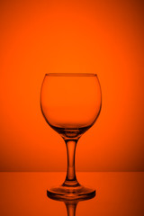 Wine glass on orange background