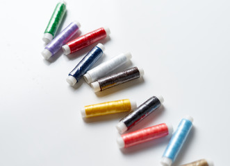 Colorful threads on white background