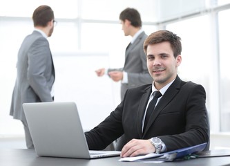 successful businessman sitting at Desk in office