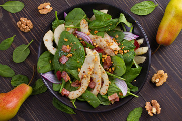 Warm spinach pear and bacon salad. View from above, top