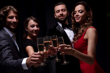Cheerful people celebrating a sucess with Champagne