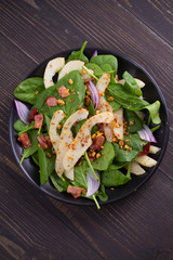 Warm spinach pear and bacon salad. View from above, top