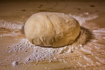 The piece of dough on the table