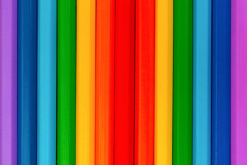 Background of colorful wooden pencils. Rainbow colors. Vertical.