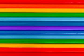Background of multicolored wooden pencils. Rainbow colors. Horizontal.