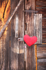 Red heart on wooden door.