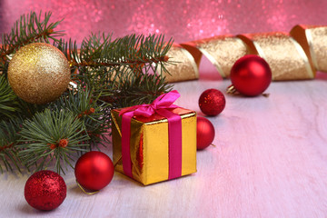 Christmas decoration with gift boxes, colorful christmas balls and christmas tree on a blurry, sparkling and fabulous background..