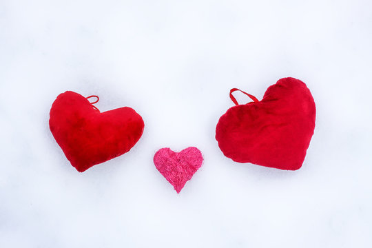 Three hearts on snow.