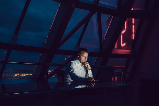 Businessman Working On Laptop In Night Office.