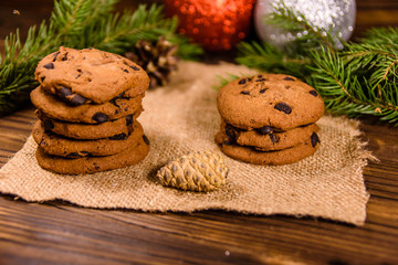 Chocolate chip cookies and christmas decorations on a wooden table