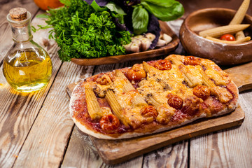 Vegetarian pizza on a wooden table. Traditional Mediterranean cuisine. Selective focus