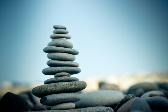 Stone Cairn On Green Blurry Background, Pebbles And Stones