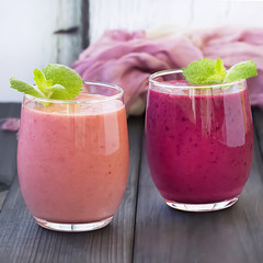 Berry smoothie on a dark wooden background.