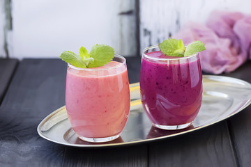 Berry smoothie on a dark wooden background.