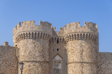 Fototapeta na wymiar Two tower of Greek castle Rhodes old medieval gate with blue sky