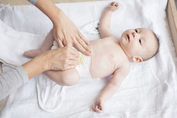 Mother happily playing with her baby after having bathed