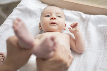 Mother happily playing with her baby after having bathed