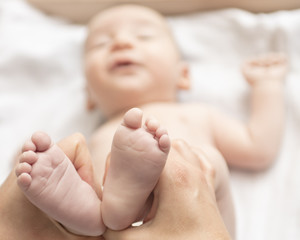 Mother happily playing with her baby after having bathed