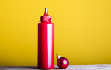 Obraz premium Ketchup. Red Christmas ball. Fashion photo. Christmas time.