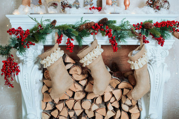 Beautiful holiday decorated room with Christmas tree, fireplace and with presents. Cozy winter scene. White interior.