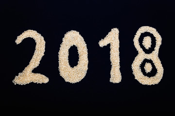 Sesame seeds on black stone background