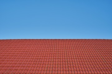Fototapeta premium Red Tiled Roof Against Clear Blue Sky